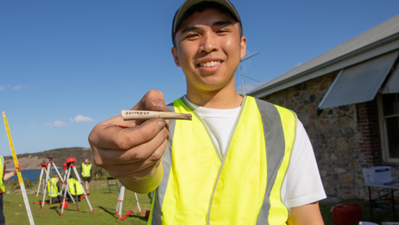 Notre Dame student with artefact from archaeological dig