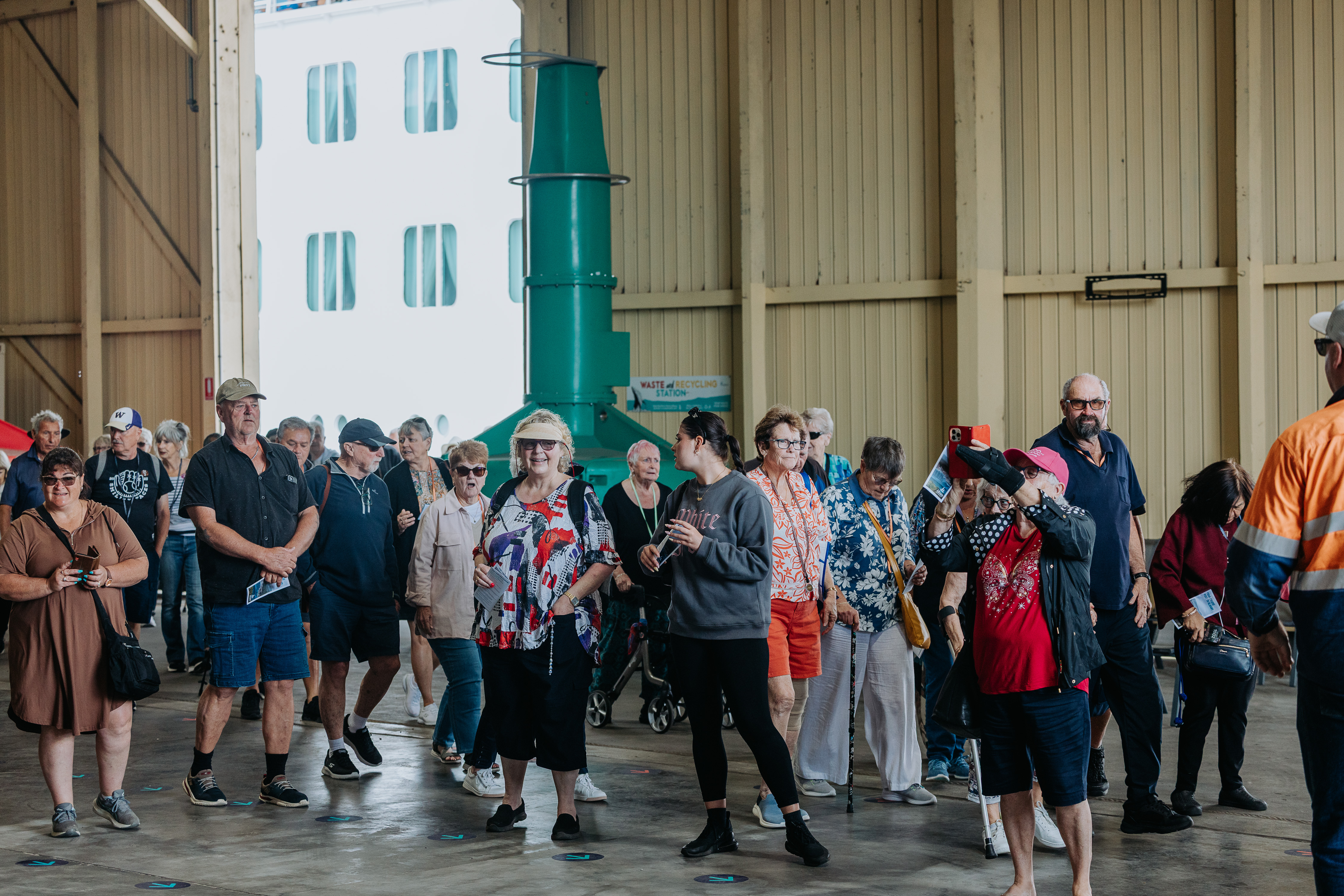Cruise passengers in transit shed