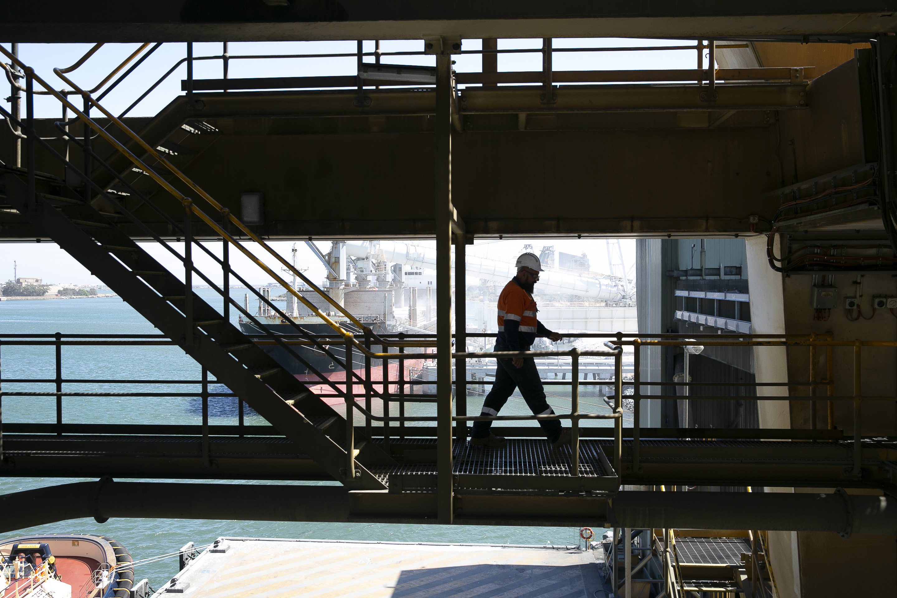 Person waking across berth 8 shiploader walkway