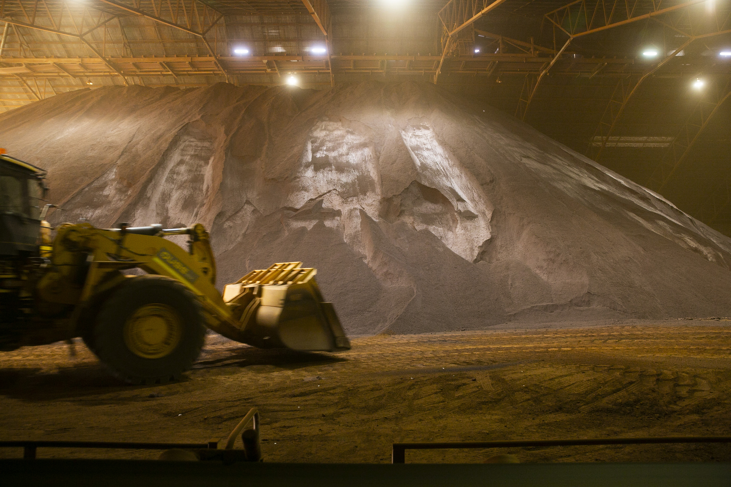 Iron ore stockpile with front end loader