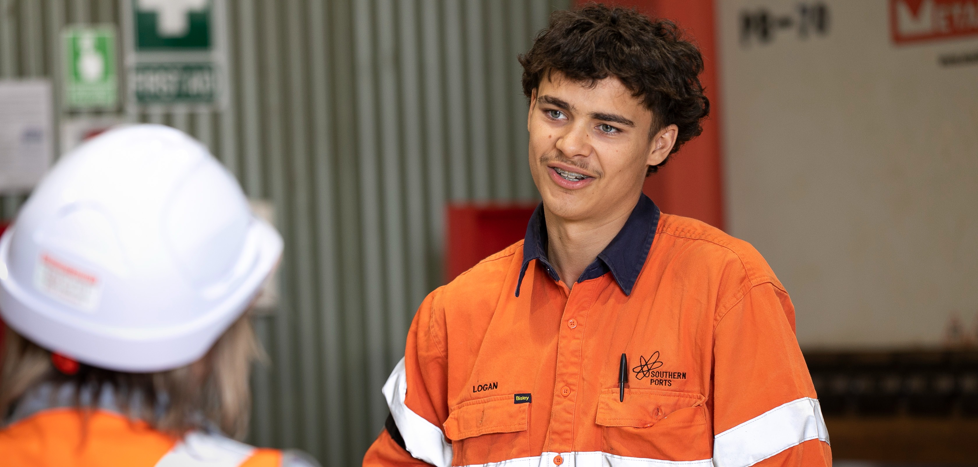 Apprentice talking to a visitor
