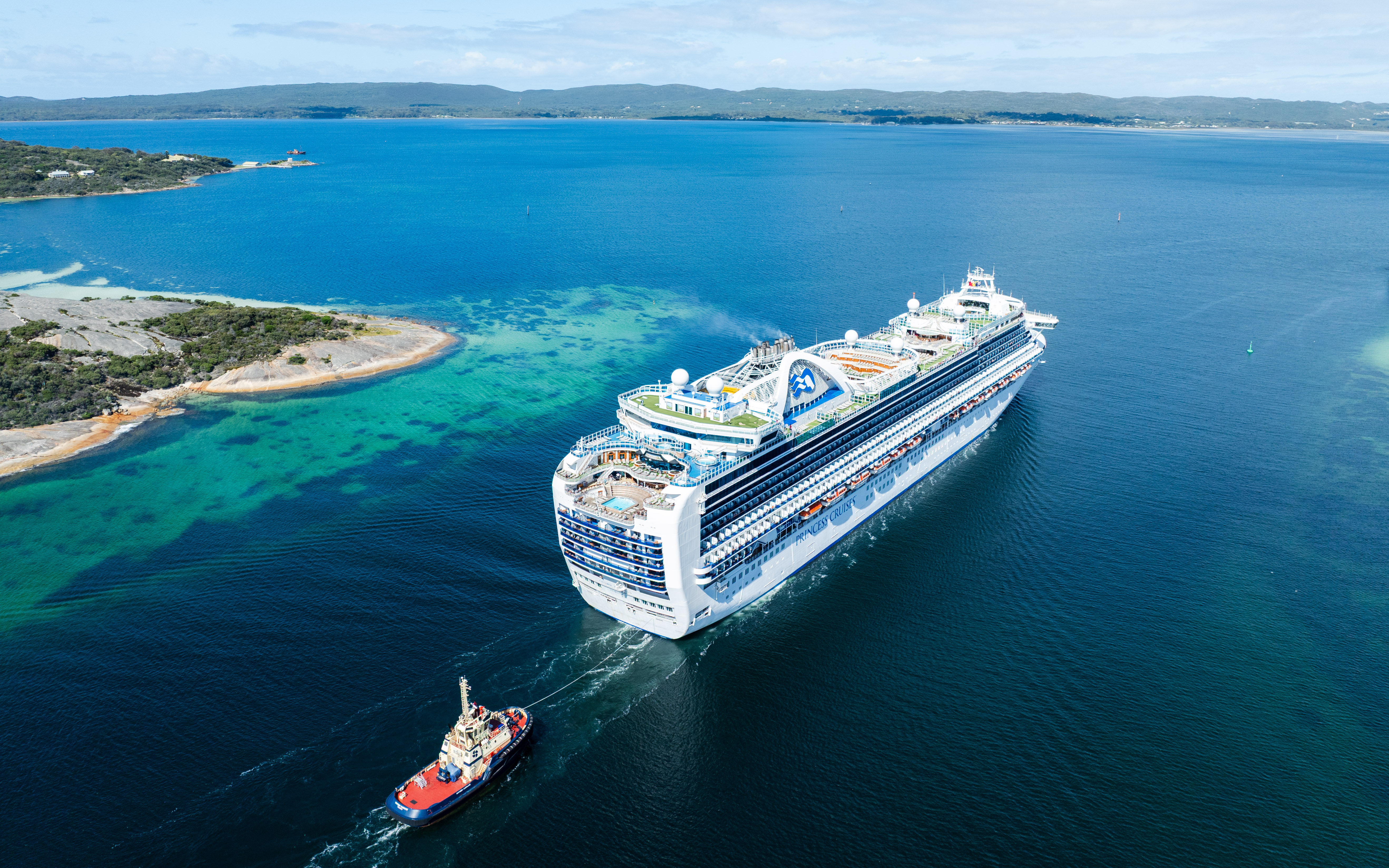 Cruise ship entering Princess Royal Harbour with tug boat