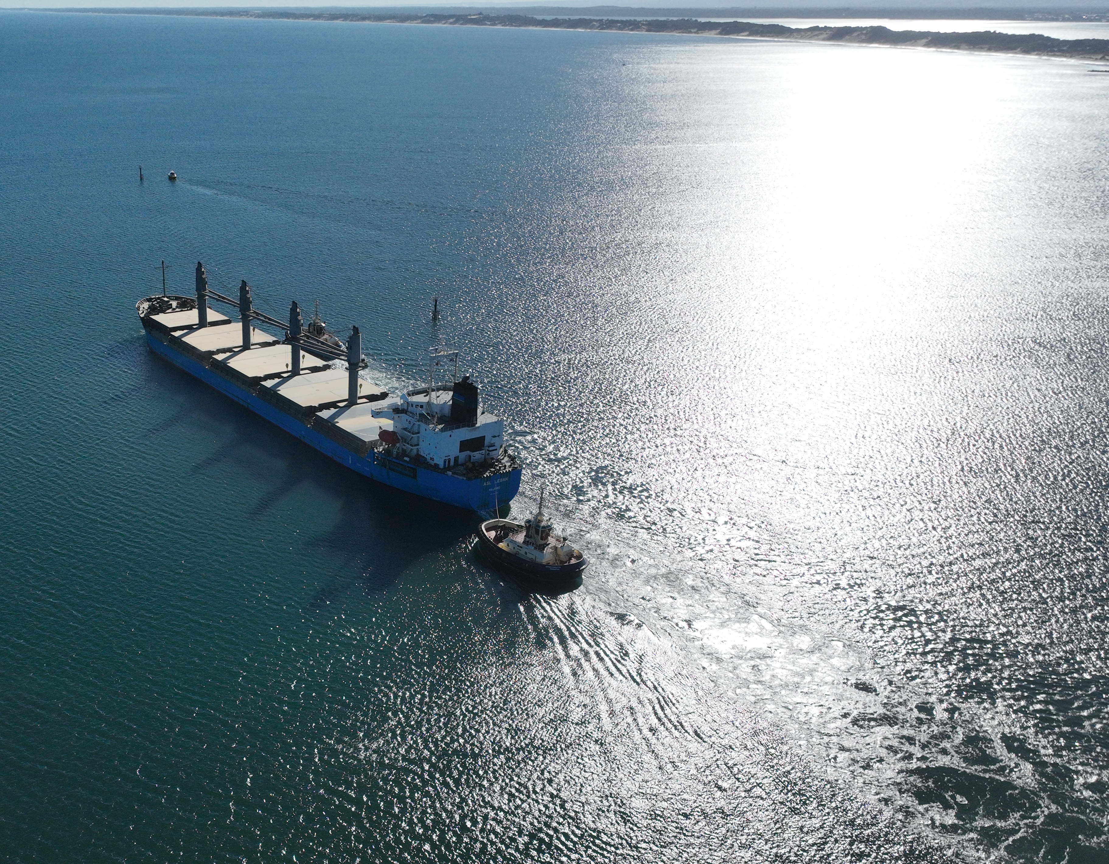 Vessel departing port with tug