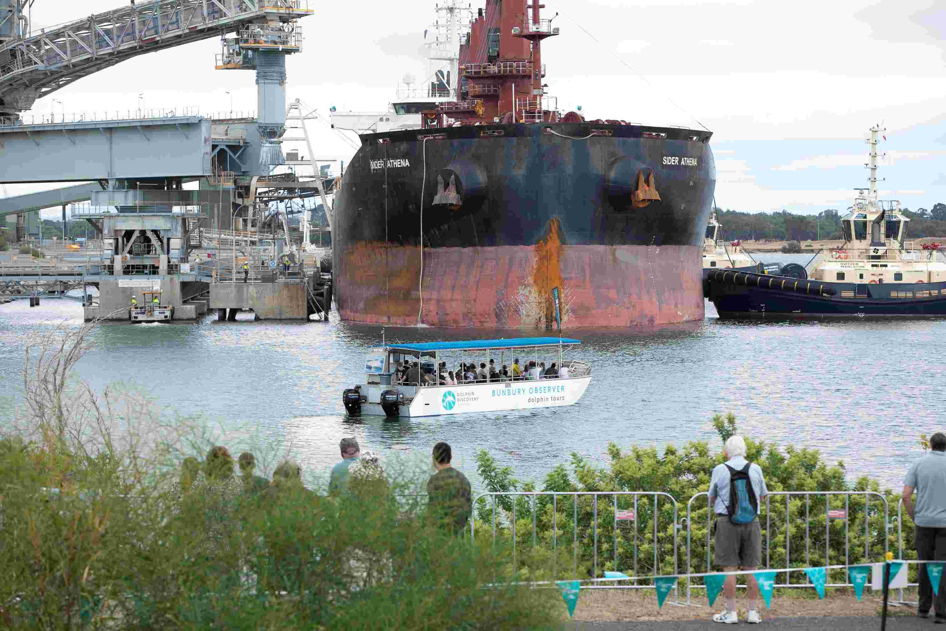 People watching a ship enter the port